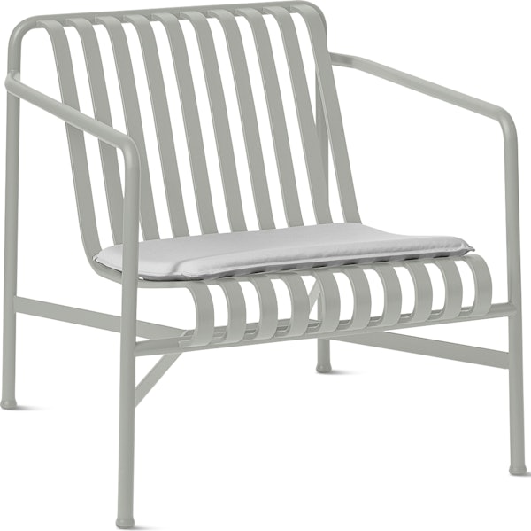 A three quarter view of a Palissade Lounge Chair with Seat Pad in light grey.